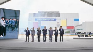Seven Samsung executives standing in front of a newly opened semiconductor factory