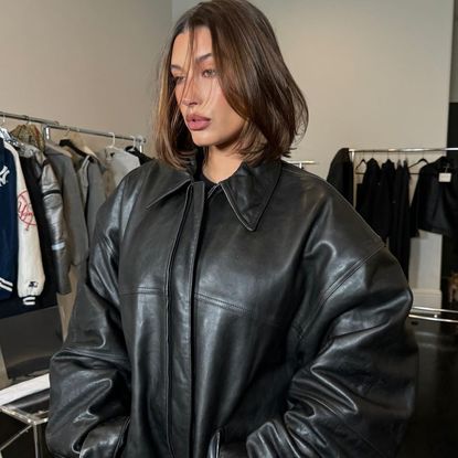 Hailey Bieber attends Coachella in an oversize leather jacket without pants