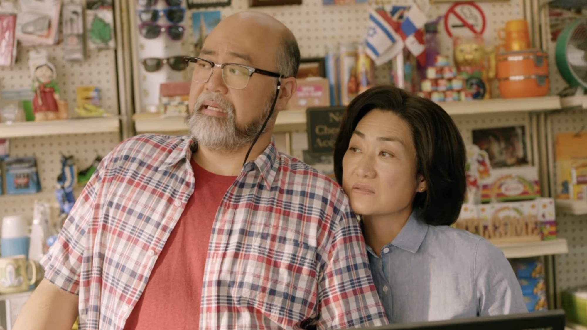 Appa and Umma watching a customer leave the store in Kim's Convenience