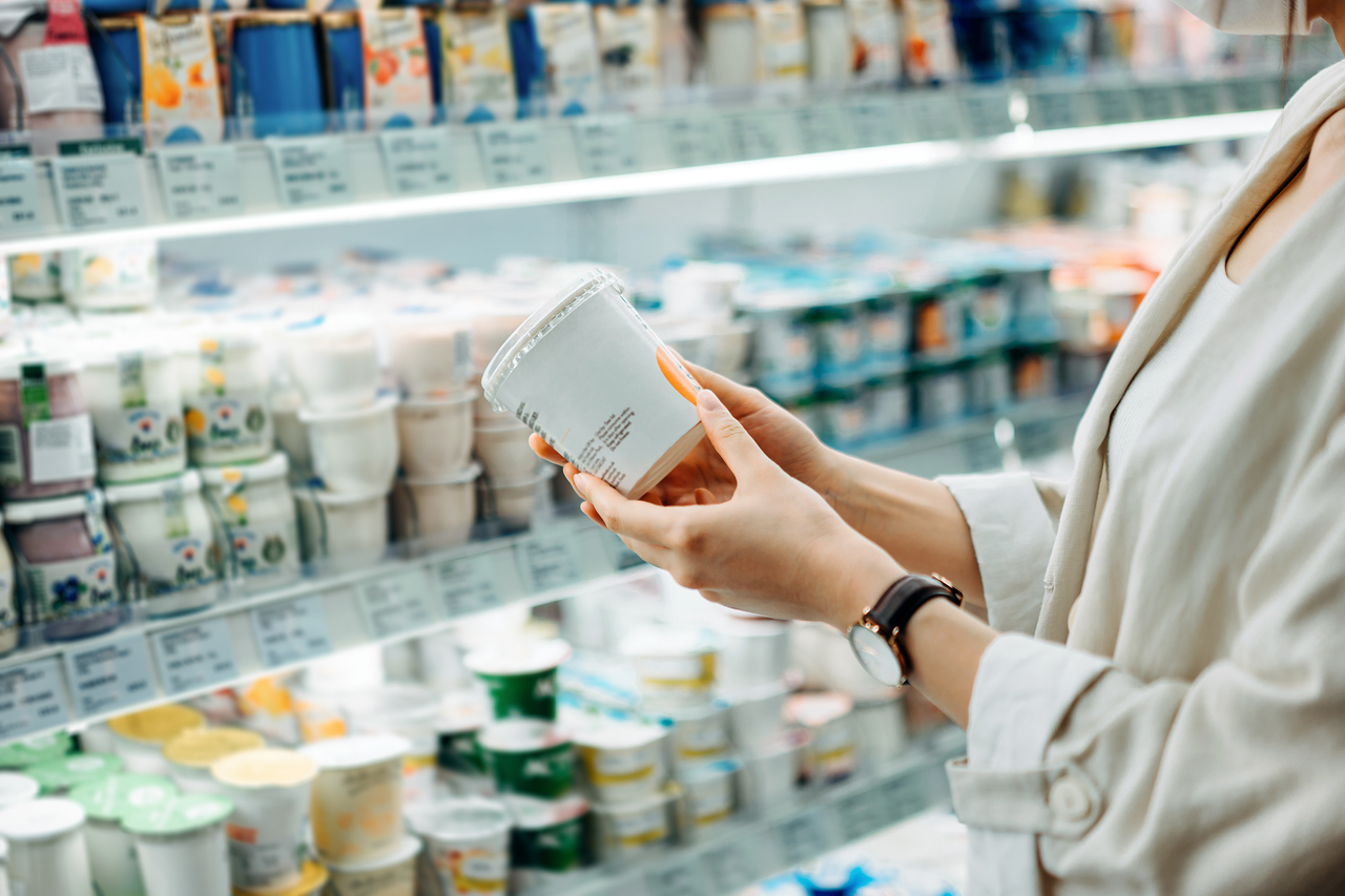 Woman looking at healthiest yogurts in the supermarket