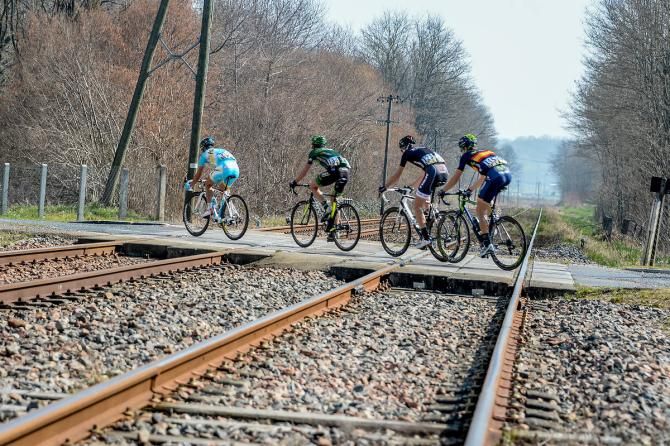 The early break of Valerio Agnoli (Astana), Perrig Quemeneur (Europcar), Laurent Didier (Trek Factory Racing) and Spanish champion Jesus Herrada (Movistar) negotiate a set or railroad tracks
