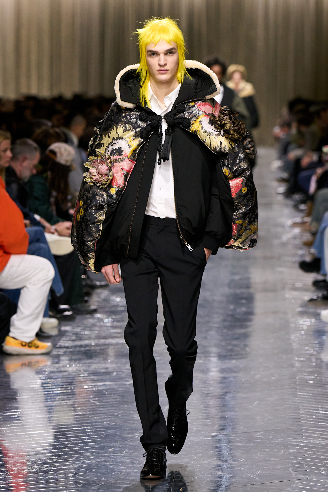 A model wearing Rihanna's puffer cape-coat hybrid on the Dior Men's Fall 2026 runway
