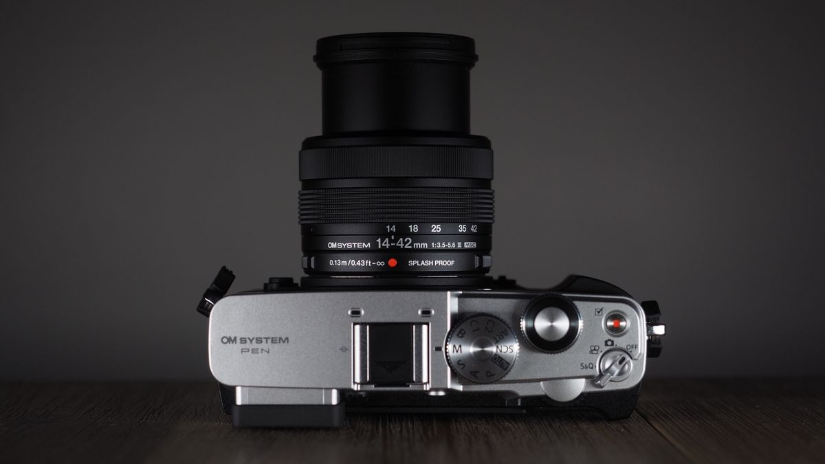 OM System OM-3 with the OM System M.Zuiko 14-42mm 3.5-5.6 III on a wooden surface