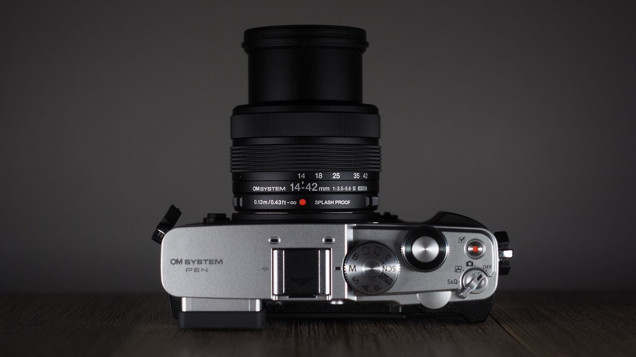 OM System OM-3 with the OM System M.Zuiko 14-42mm 3.5-5.6 III on a wooden surface