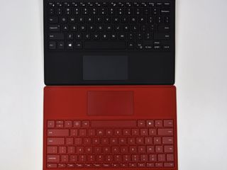 Dell Travel Keyboard (top, black) is a mirror image of Microsoft's Surface Type Cover (bottom, red).