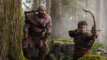 Ryan Hurst's Kratos crouching near Atreus (Callum Vinson) in first look at God of War series