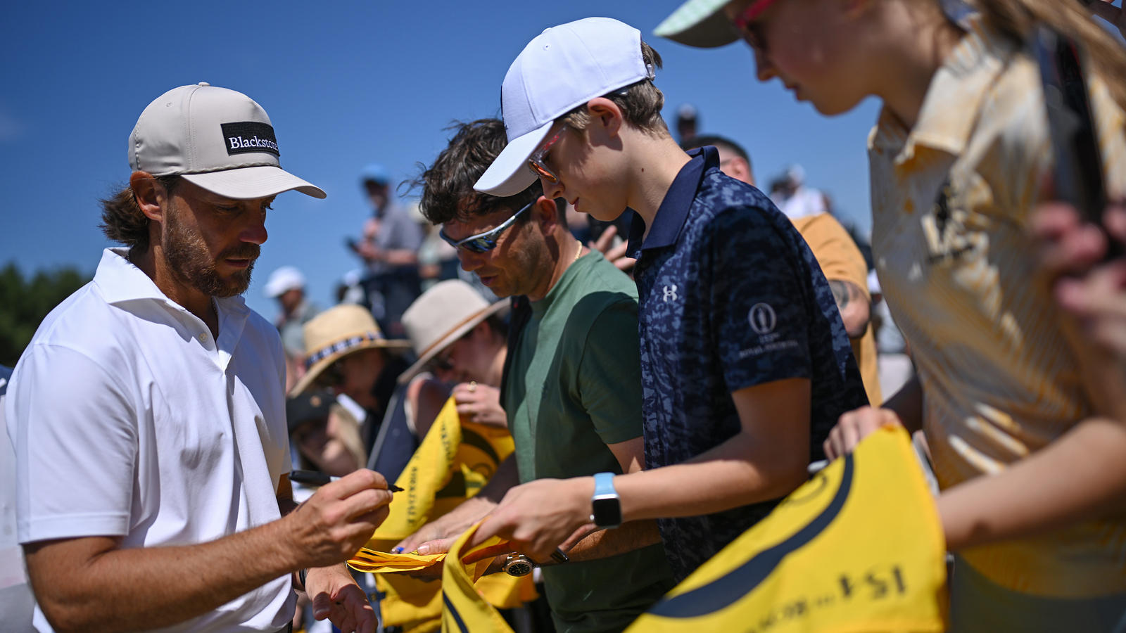 Tommy Fleetwood signs autographs on flags