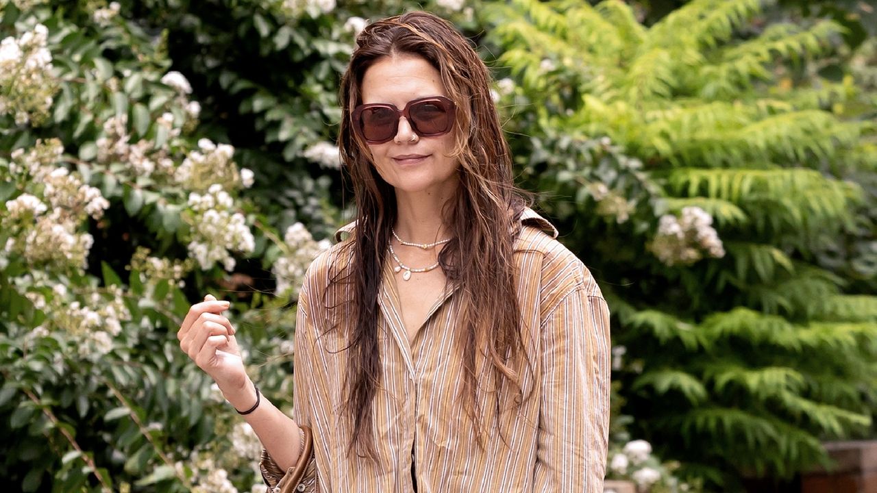 Katie Holmes is seen out and about wearing sunglasses and an oversized shirt on August 11, 2024 in New York