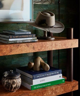 burl wood shelving with western inspired decor accessories including a cowboy hat