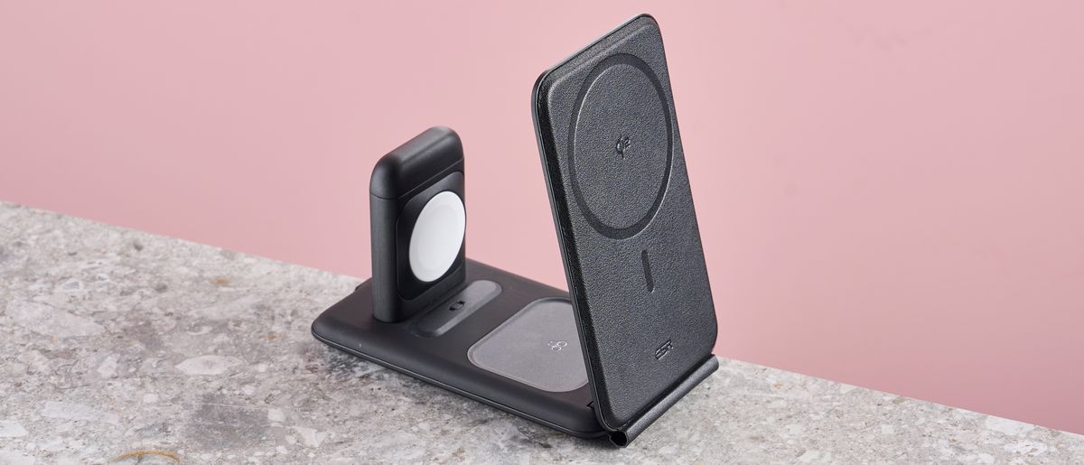 The ESR Qi2 3-in-1 travel wireless charger sits on a stone-effect surface in front of a pink background.