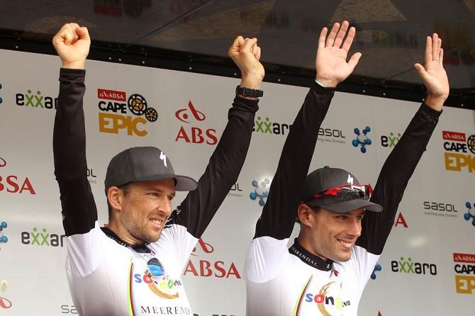 Christoph Sauser and Frantisek Rabon of Meerendal Songo Specialized celebrate on the podium after winning Stage 3