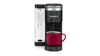 Black Keurig K-Supreme SMART coffee maker brewing into a red mug