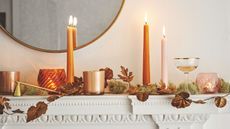 Mantel with candles and fall leaf decorations displayed