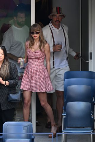 Taylor Swift at the US Open wearing a Reformation dress and Gucci sandals