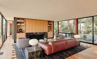 Open plan living room with a brown leather sofa
