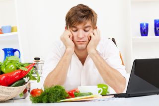 A man looks at his vegetables with disdain