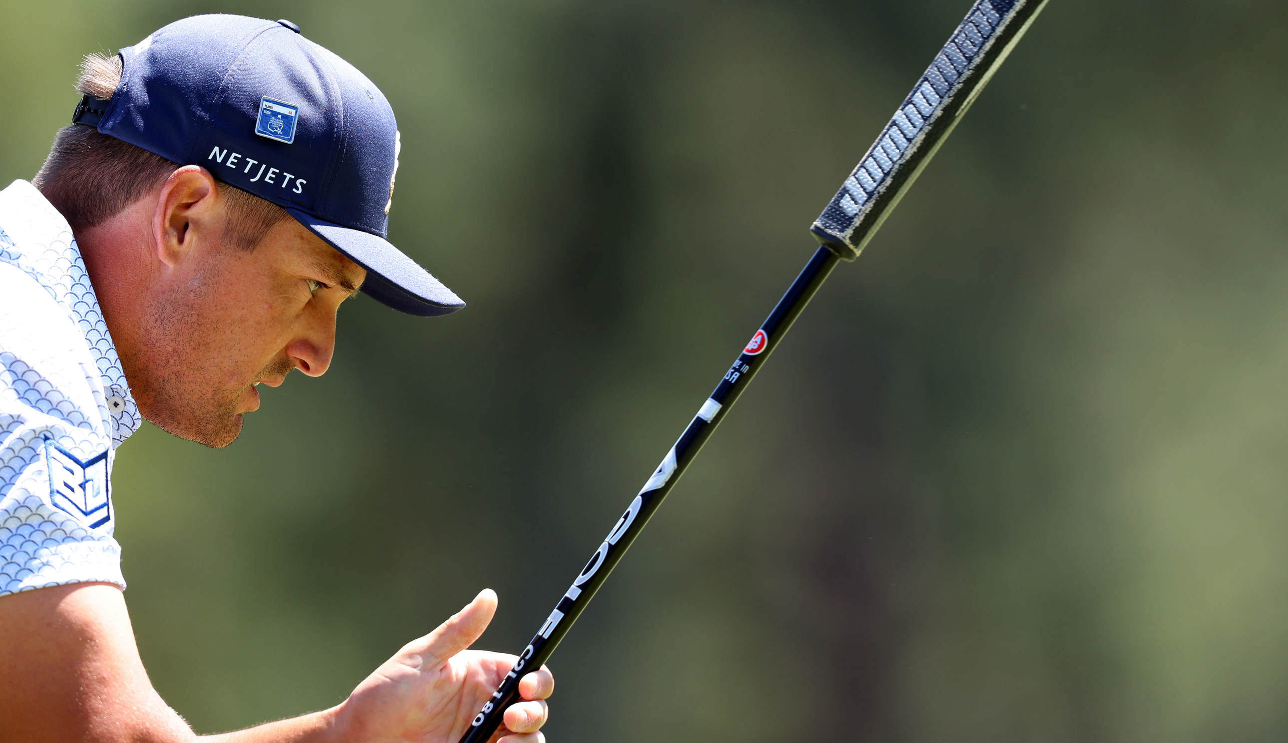 Bryson DeChambeau lines up a putt