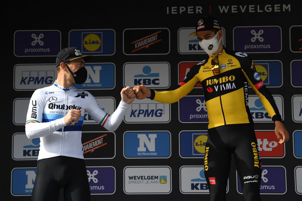 WEVELGEM BELGIUM MARCH 28 Podium Giacomo Nizzolo of Italy and Team Qhubeka Assos Wout Van Aert of Belgium and Team Jumbo Visma Celebration during the 83rd GentWevelgem in Flanders Fields 2021 Mens Elite a 254km race from Ypres to Wevelgem Celebration Social distancing Mask Covid Safety Measures GWE21 GWEmen FlandersClassic on March 28 2021 in Wevelgem Belgium Photo by Tim de WaeleGetty Images