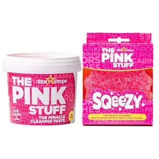 A tub of The Pink Stuff and a pink sponge scrubber