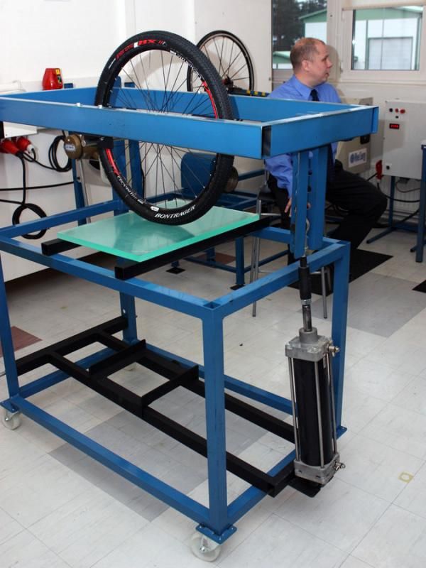 The tyre contact patch test station incorporates a hydraulic cylinder to apply a consistent load.
