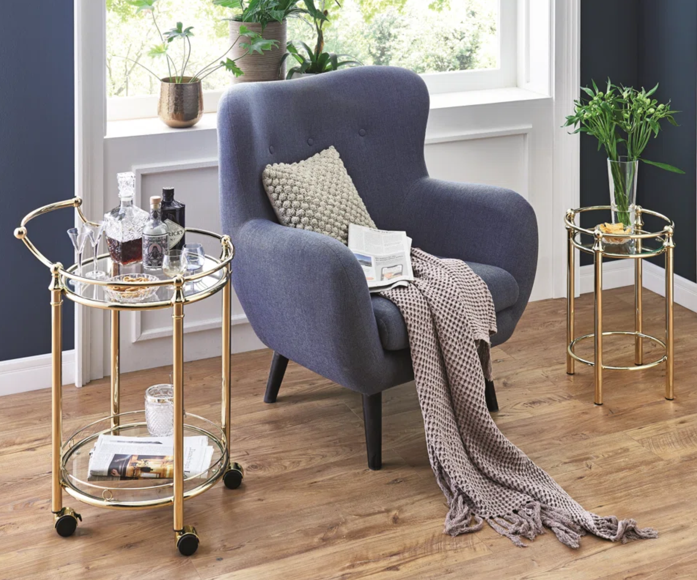 Blue chair with gold drinks trolley next to it