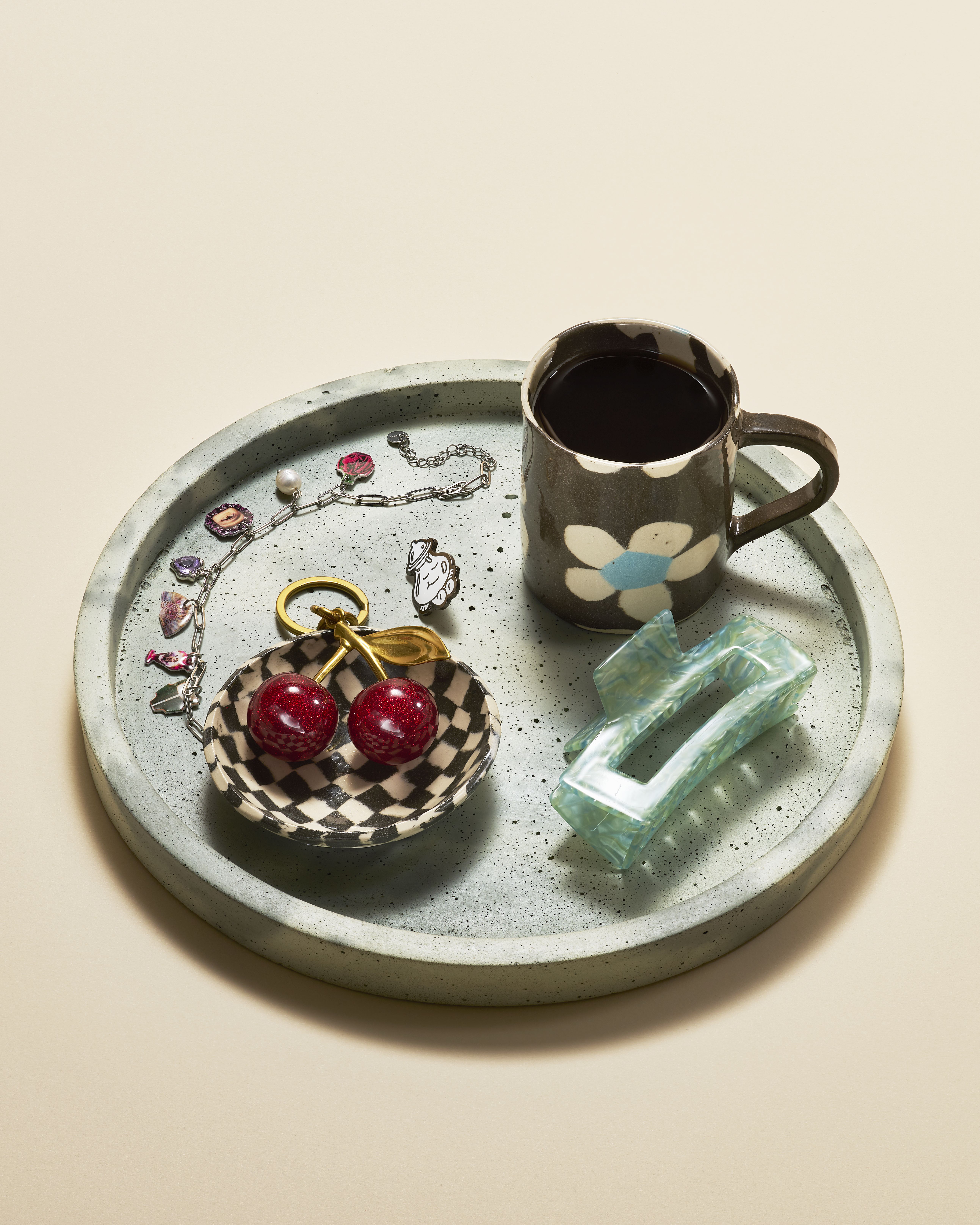 A series of product shots of colorful jewelry, design objects, and fashion accessories, as well as artist portraits of artisans in their busy studios.