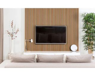 A large flat screen TV on wall against strips of acoustic wood paneling