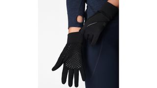 woman wearing Sweaty Betty gloves