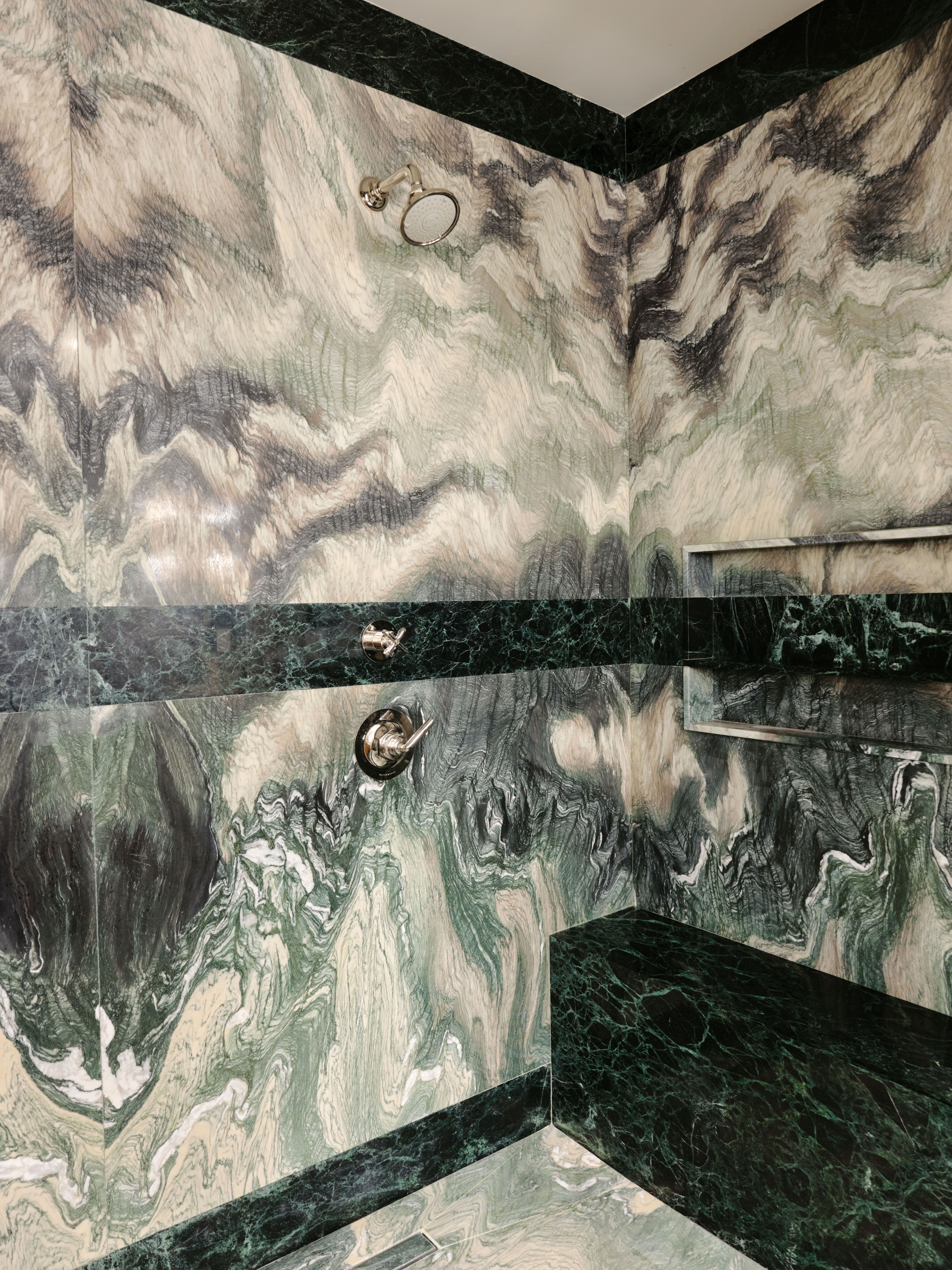 Marble shower area with ledge seating