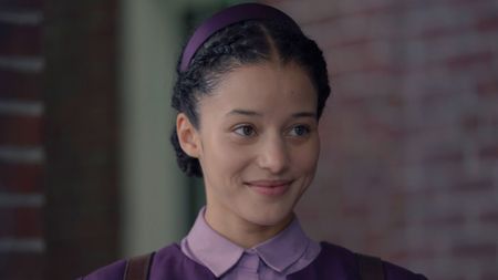 Agnes looks at something offscreen