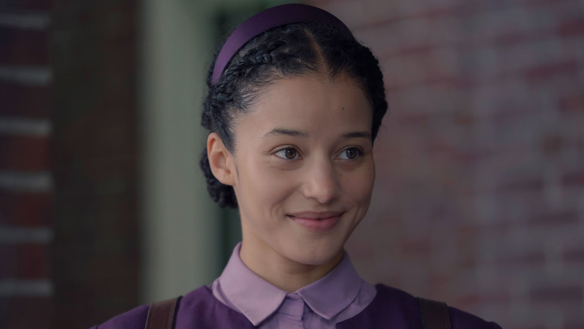 Agnes looks at something offscreen