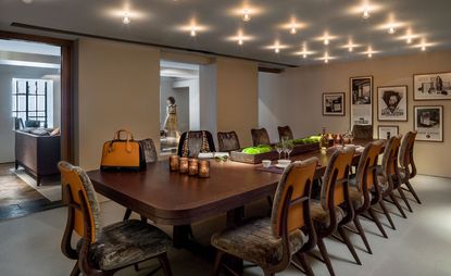 Large wooden dining table with velvet seats