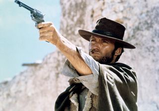 Clint Eastwood as Blondie (the Man with No Name), holding a gun in the air in a still from The Good, the Bad and the Ugly