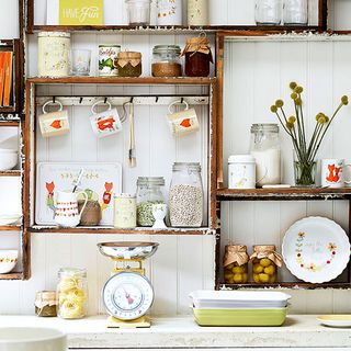 kitchen with wooden wall mounted shelf with crockery