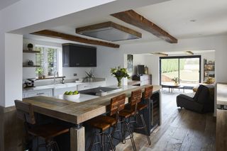 open plan kitchen and living space with ceiling extractor fan and beams