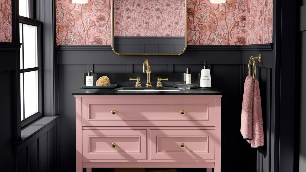 pink sink vanity with black wall panelling and floral pink wallpaper