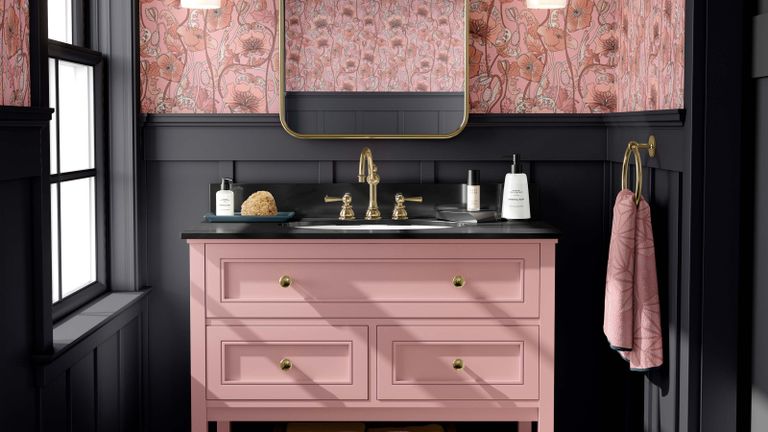 pink sink vanity with black wall panelling and floral pink wallpaper