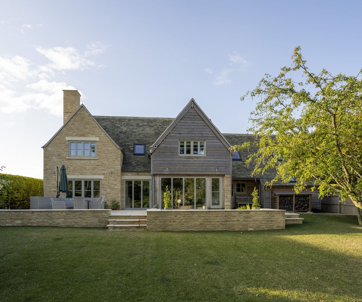 The rear exterior of an oak frame self build with timber and brick cladding