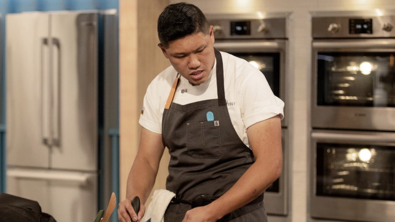 Laurence Louie in the kitchen cooking in Top Chef Season 23
