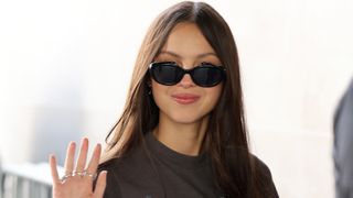 Olivia Rodrigo wears black oval sunglasses as she arrives at BBC Radio Studios on August 15, 2023 in London, England.