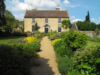 Cotswold stone house with cottage garden planting