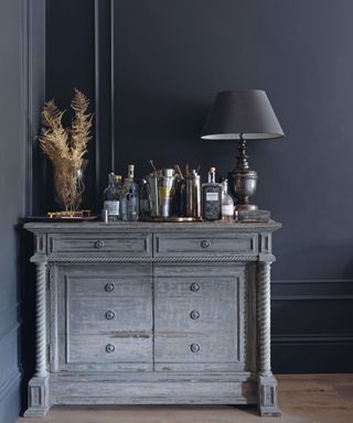 Cabinet topped with barware in a living room of a Georgian home