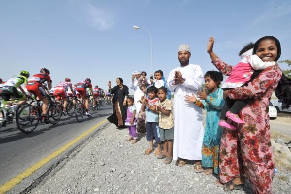 Racers roll past spectators
