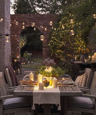 alfresco table with lit trees surrounding