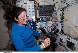 NASA astronaut Nicole Stott, STS-133 mission specialist, wears