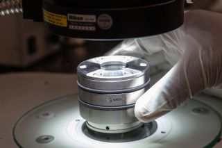 A scientist analyzes a sample of Ryugu collected by the Japanese Hayabusa2 spacecraft.