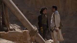 May Calamawy and Oscar Isaac stand opposite outside a tomb in Moon Knight