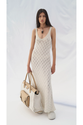 A model wearing a white Chloé knit maxi dress and woven slides
