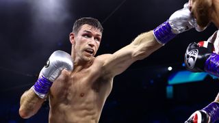  Callum Smith, in red and white shorts and silver boxing gloves, punches an opponent ahead of the Beterbiev vs Smith live stream