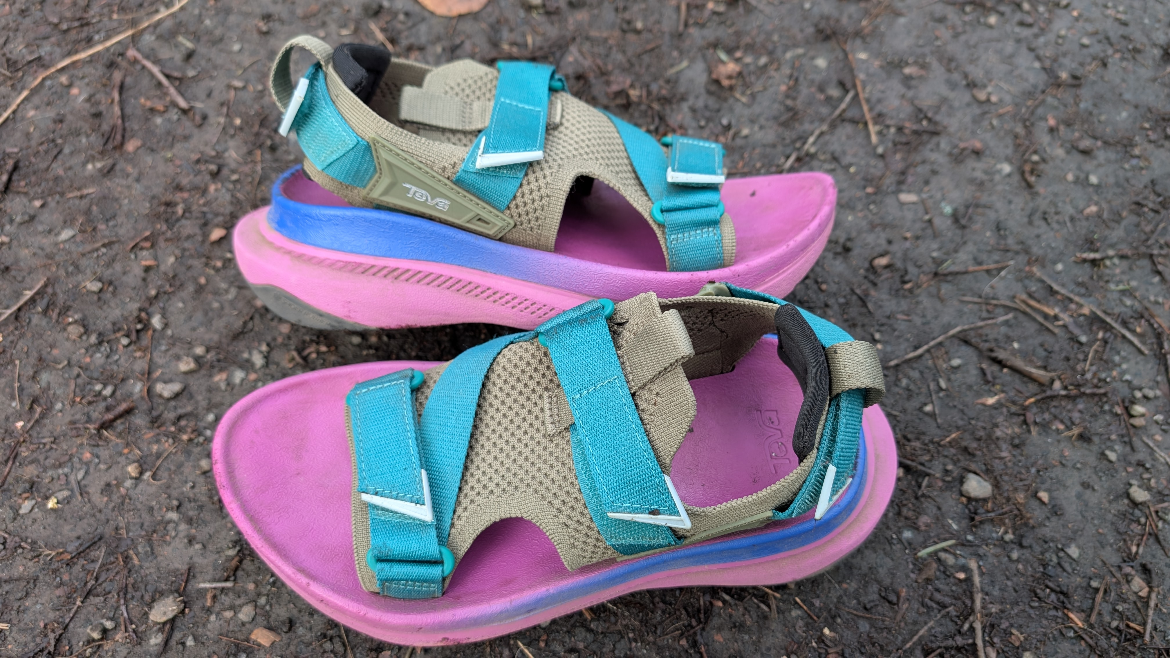 Pink and blue Teva Aventrail running sandals on the trail